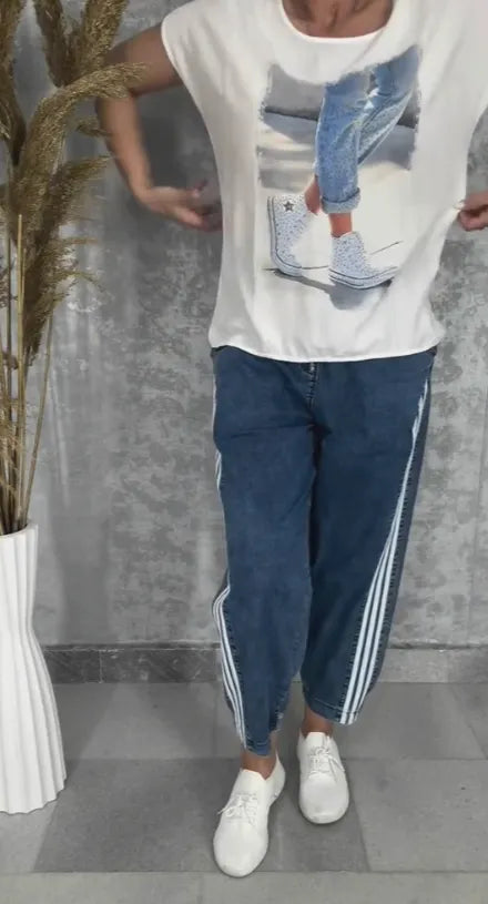 T-shirt with a round neckline batwing sleeves jeans with three stripes on the sides set